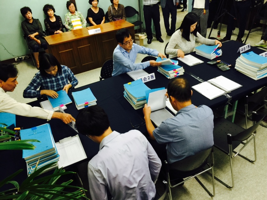 위원회 직원들이 위원회 사무실에서 주민소환투표청구서명부를 확인하는 있는 모습