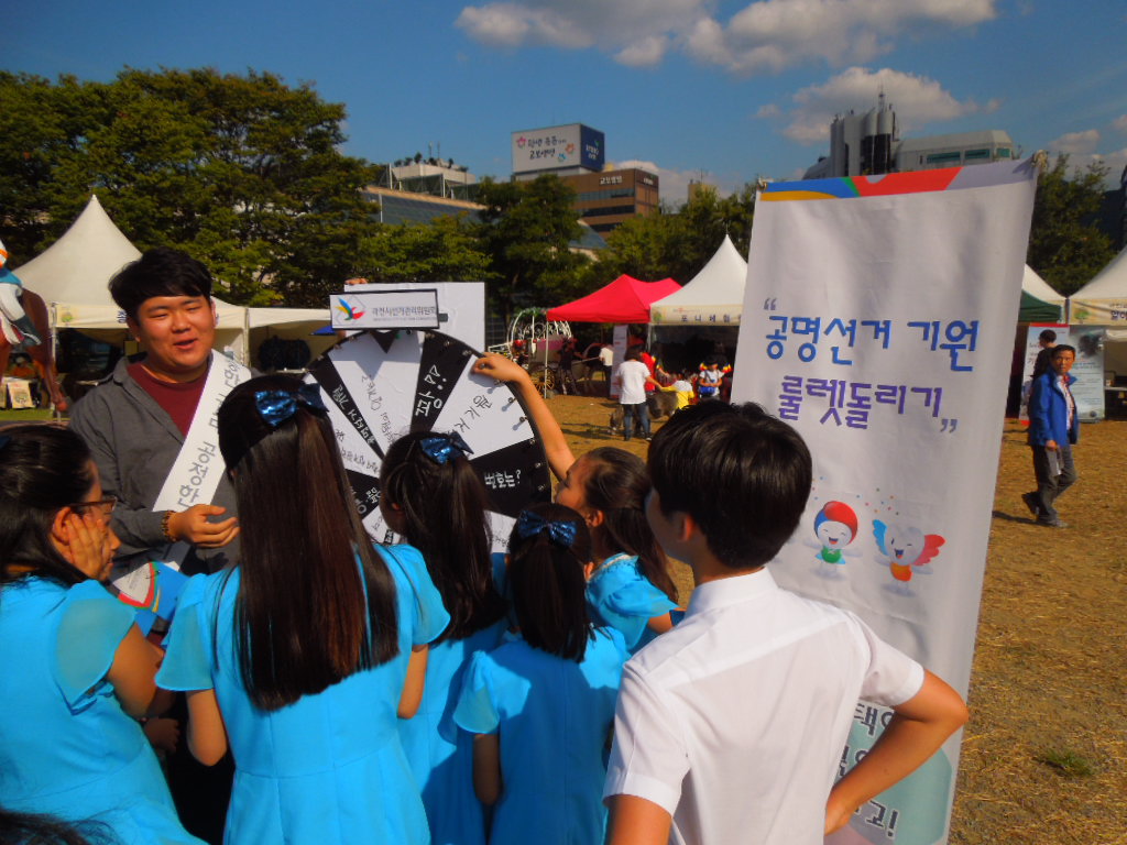 위원회 직원들이 과천축제 종합안내소 앞 잔디마당에서 룰렛돌리기를 하는 모습