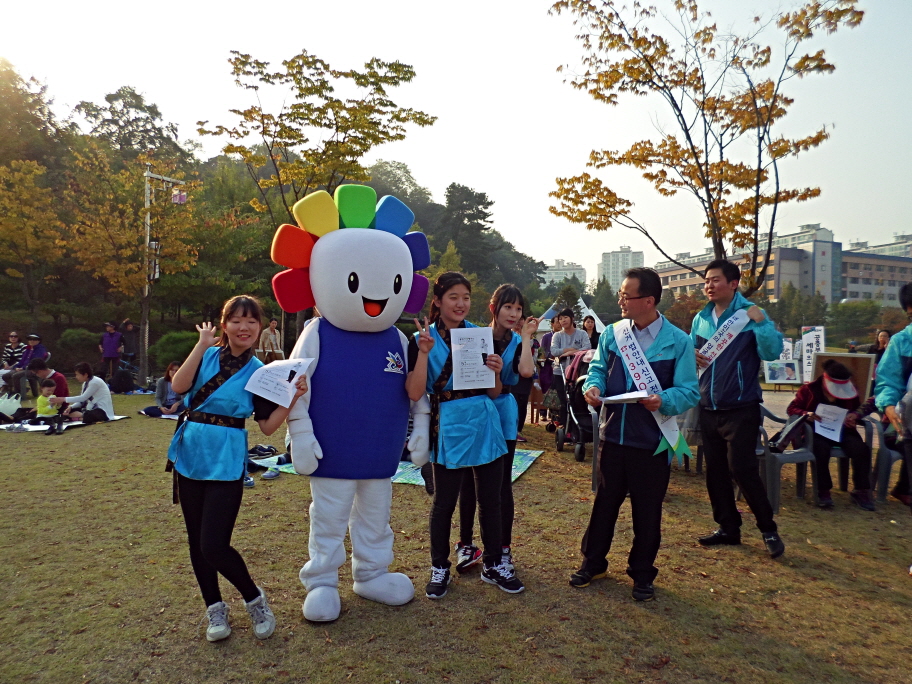 제6회 독산성문화제에 참가한 학생들이 위원회 마스코트인 참참이와 기념촬영을 하고 있는 모습의 사진입니다
