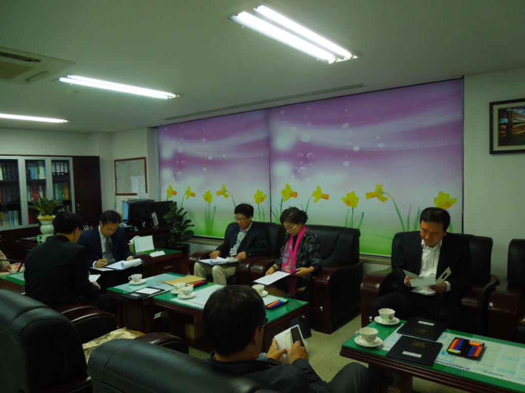 위원회 회의실에서 위원회의시 사무국장이 업무보고를 하는 모습