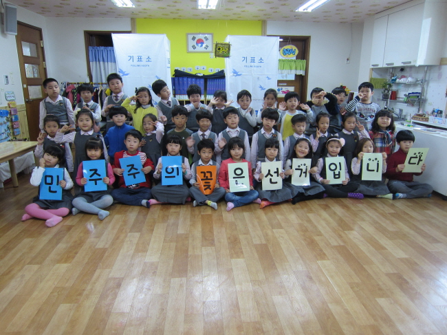 민주주의 꽃 플래카드를 들고 기념사진 촬영 한 컷