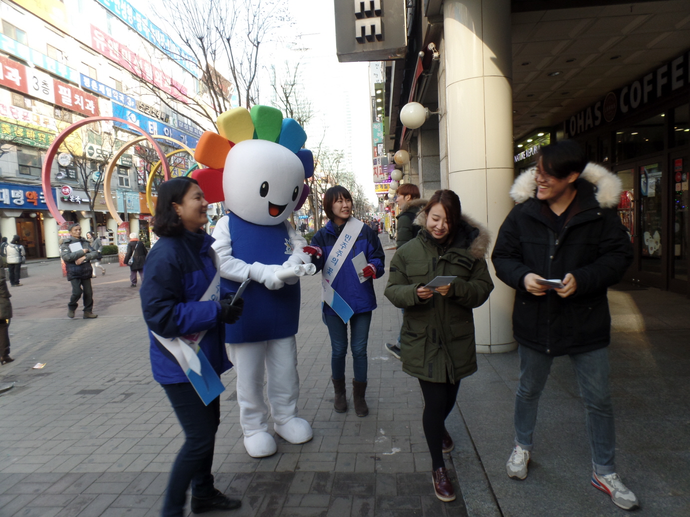 위원회 직원들이 시민들에게 기부행위관련 제도 안내 및 홍보용품과 홍보리플릿을 배부하는 모습
