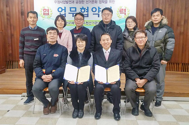 2016년 2월 17일 동두천시 우체국 회의실에서 동두천시선거관리위원회 사무과장 및 임직원과 동두천시우체국 총괄국장 및 우체국 직원들과의 업무협약 체결식 후 기념사진을 함께 찍는 모습의 사진